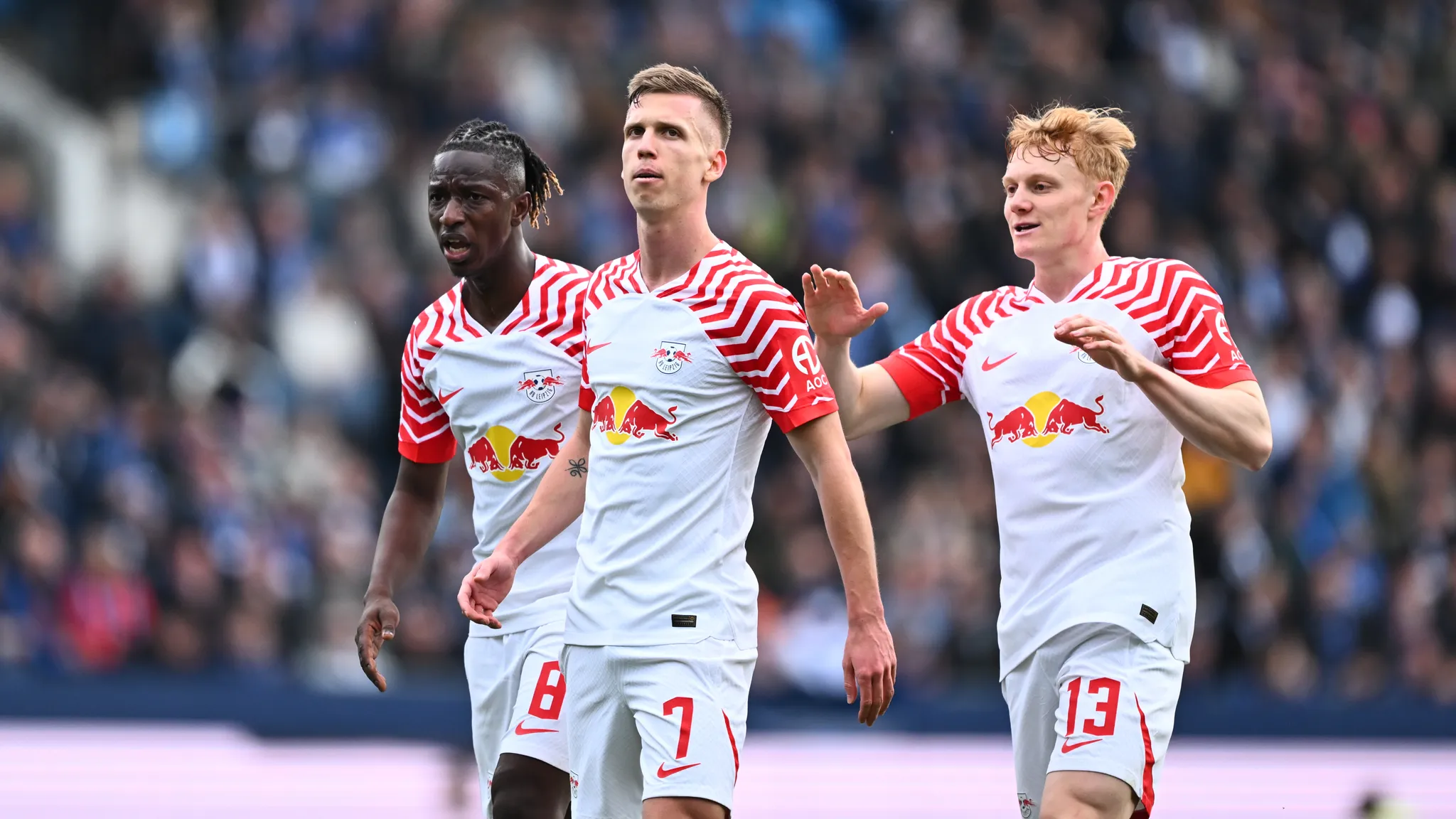 Amadou Haidara, goal scorer Dani Olmo and Nicolas Seiwald celebrate the 1-1 equaliser.