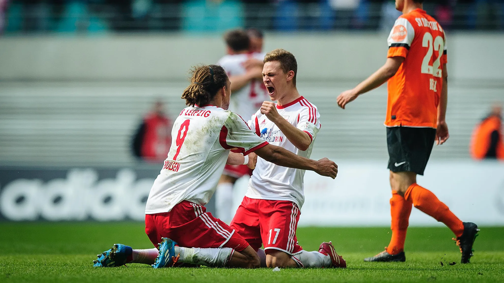 Yussuf Poulsen and Joshua Kimmich cheering after the win against SV Darmstadt 98 in 2014.