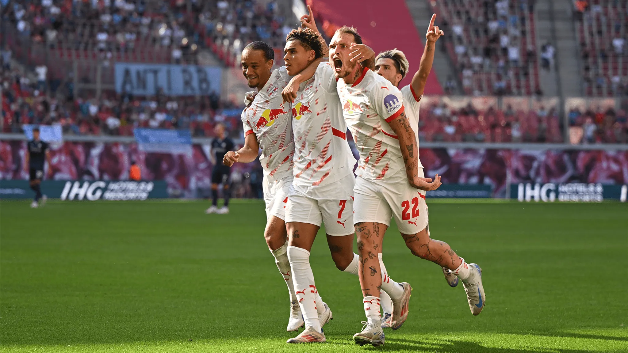 Xavi and David Raum celebrate Antonio Nusa's first Bundesliga goal.