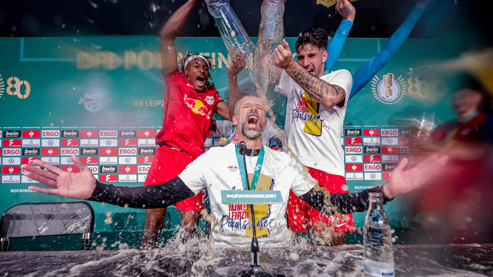 Marco Rose is drenched in beer after the DFB Cup win.