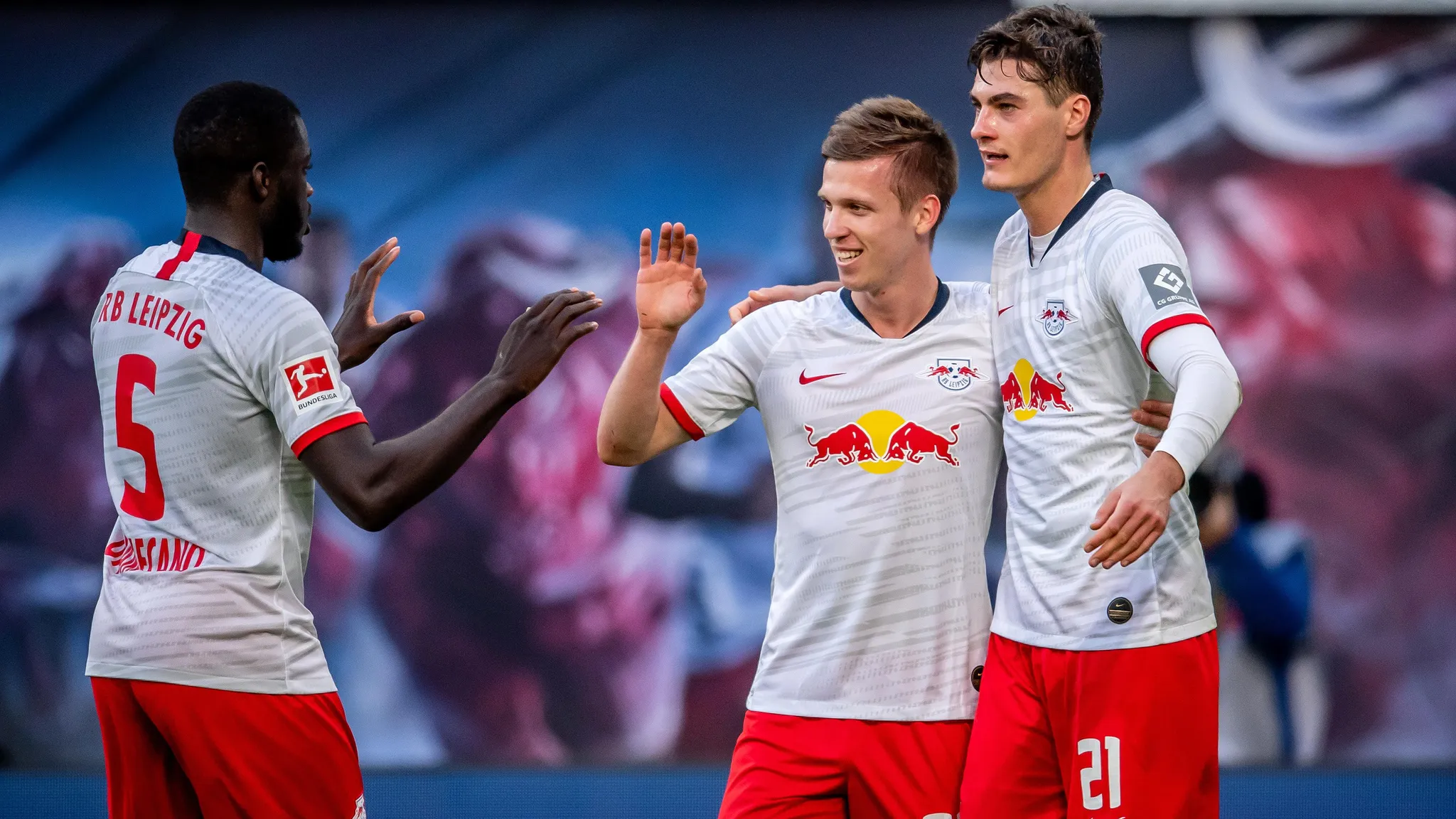 Dani Olmo celebrates his first goal for RB Leipzig. Next to him: Dayot Upamecano and Patrik Schick.