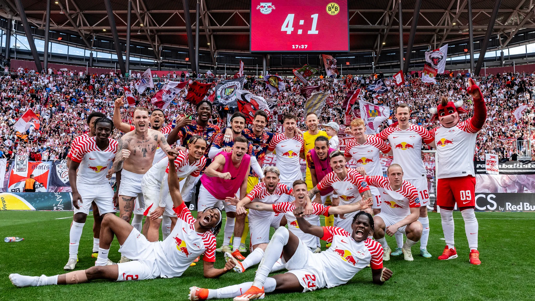 The players of RB Leipzig celebrate in front of their own stands after their home victory against Borussia Dortmund.