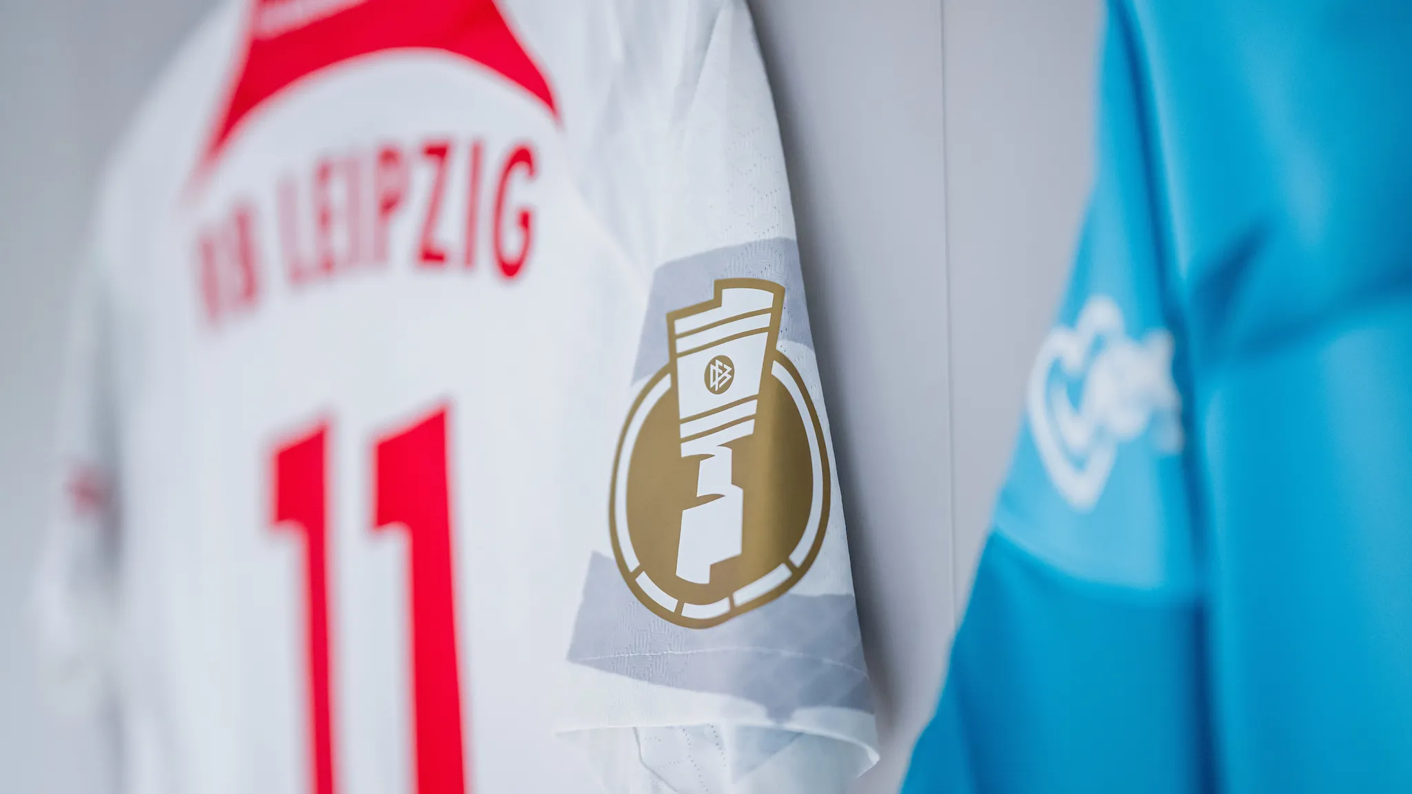 RB Leipzig's home jersey with the golden DFB-Pokal logo on the sleeve.