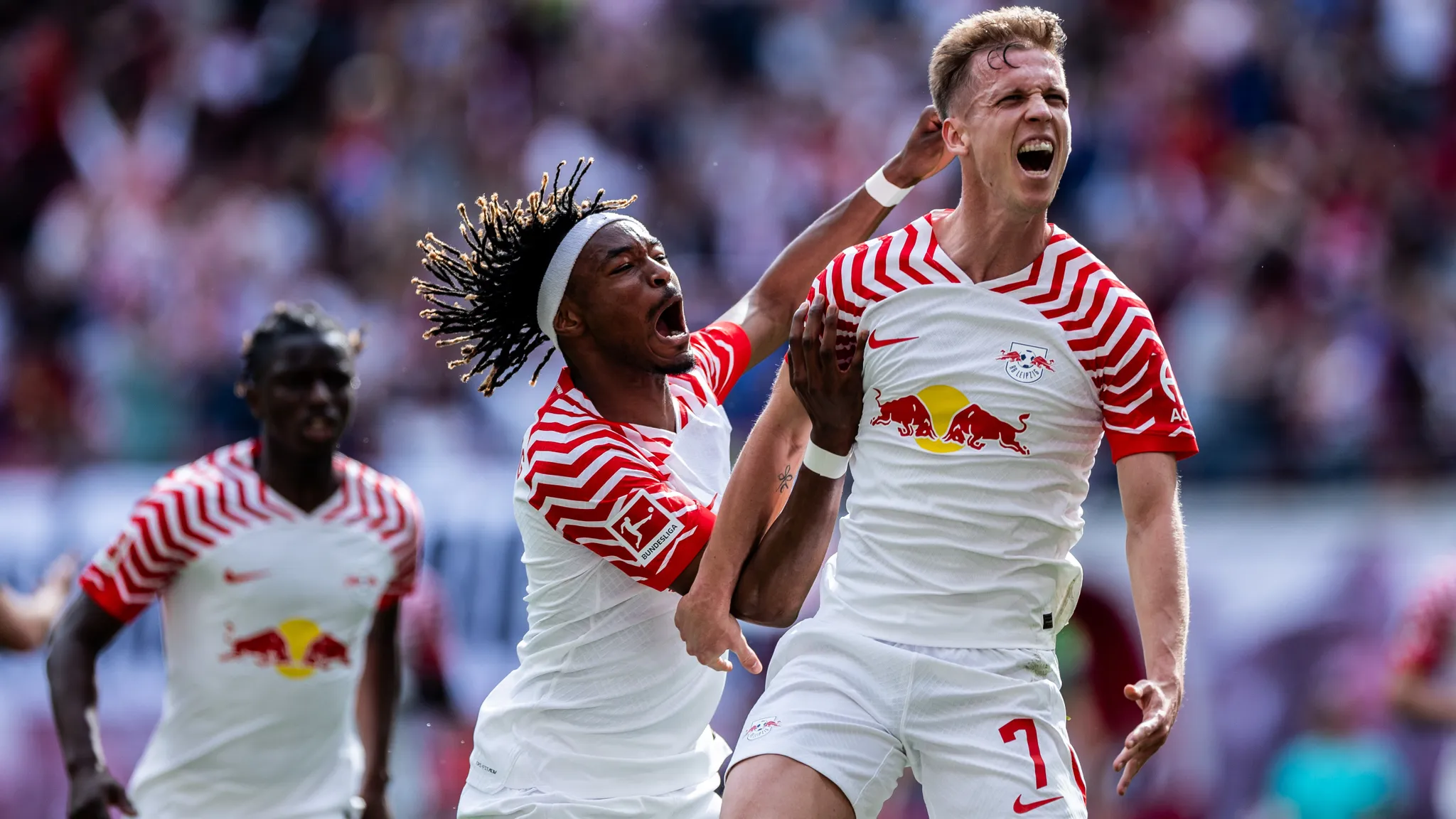 Dani Olmo celebrates his goal against VfL Wolfsburg with Mohamed Simakan.